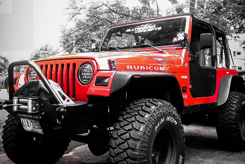 Red jeep 4x4 off-road vehicle with All Terrain Concepts led off-road lights. 